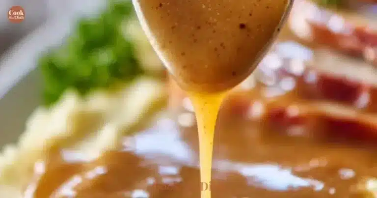 Homemade make ahead turkey gravy in a bowl with fresh herbs